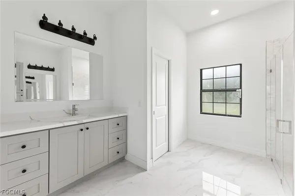 a bathroom with a double vanity sink and mirror