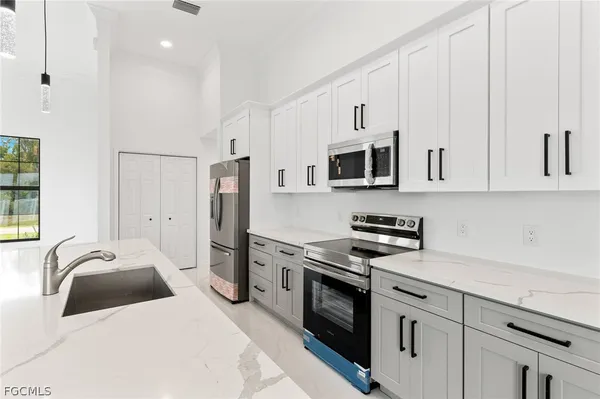 a kitchen with stainless steel appliances a stove microwave and refrigerator