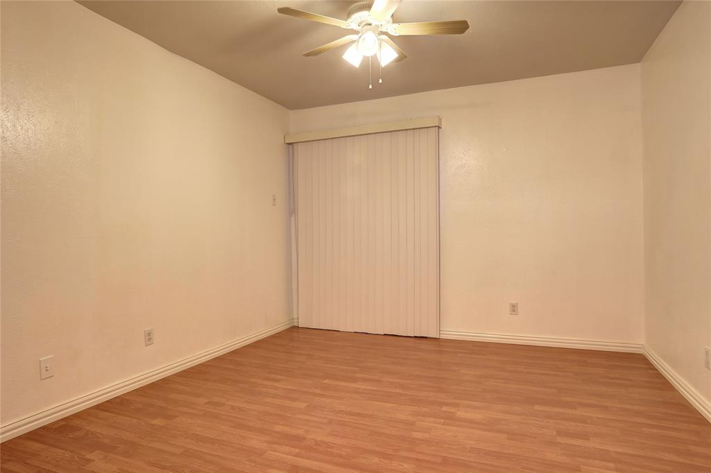 4314 Travis Street, Unit 102 Dallas, TX 75205 - Photo 5 of 9 a view of an empty room with wooden floor