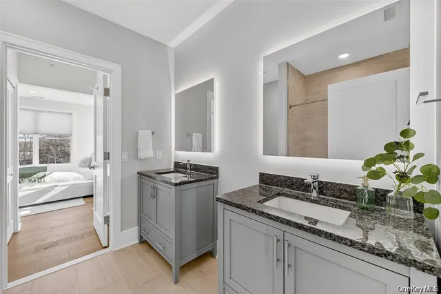 a living room with granite countertop a sink and a stove