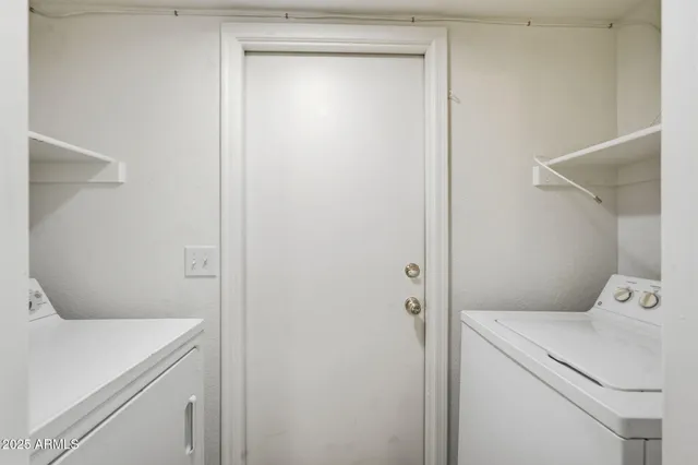 a view of bathroom with washer and dryer