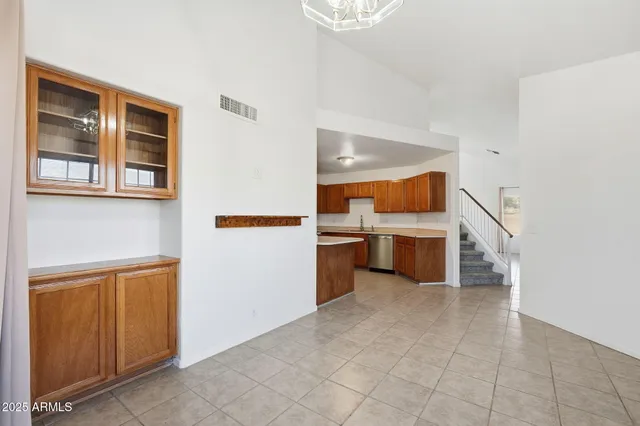 a view of a kitchen with furniture and an empty room
