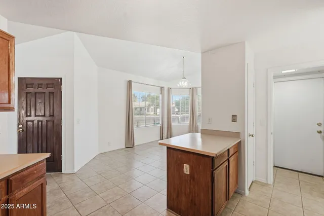 a kitchen with granite countertop a sink and a refrigerator
