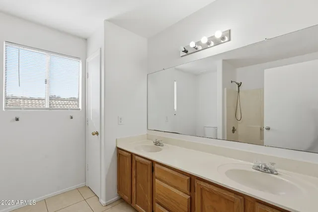 a bathroom with a double vanity sink and a mirror