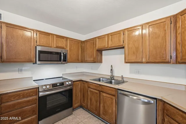 a kitchen with stainless steel appliances granite countertop a sink stove and microwave