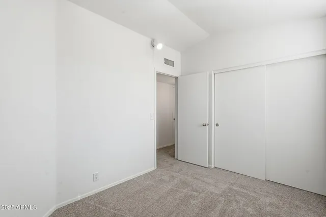 an empty room with a empty space and a ceiling fan