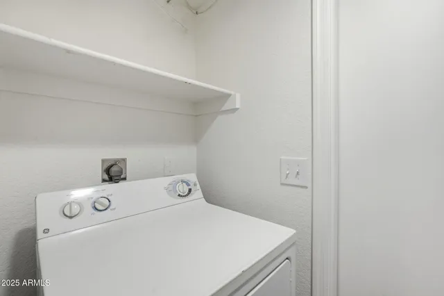 a view of a house with a yard and palm trees