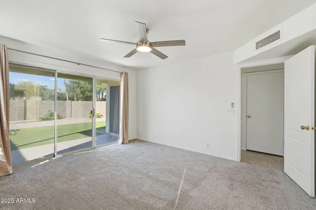 a view of room with window and ceiling fan