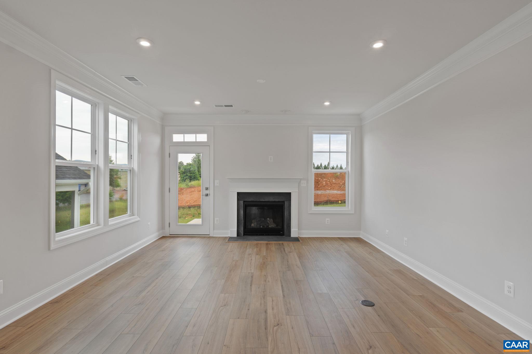 140 Springdale Road Waynesboro, VA 22980 - Photo 12 of 37 an empty room with wooden floor fireplace and windows