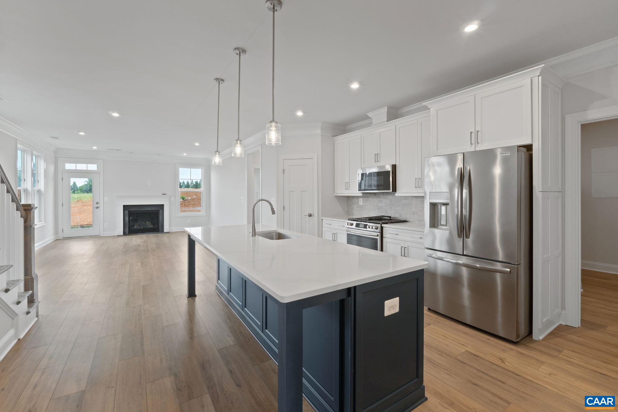 140 Springdale Road Waynesboro, VA 22980 - Photo 7 of 37 a kitchen with stainless steel appliances a refrigerator a stove a sink a dining table and chairs