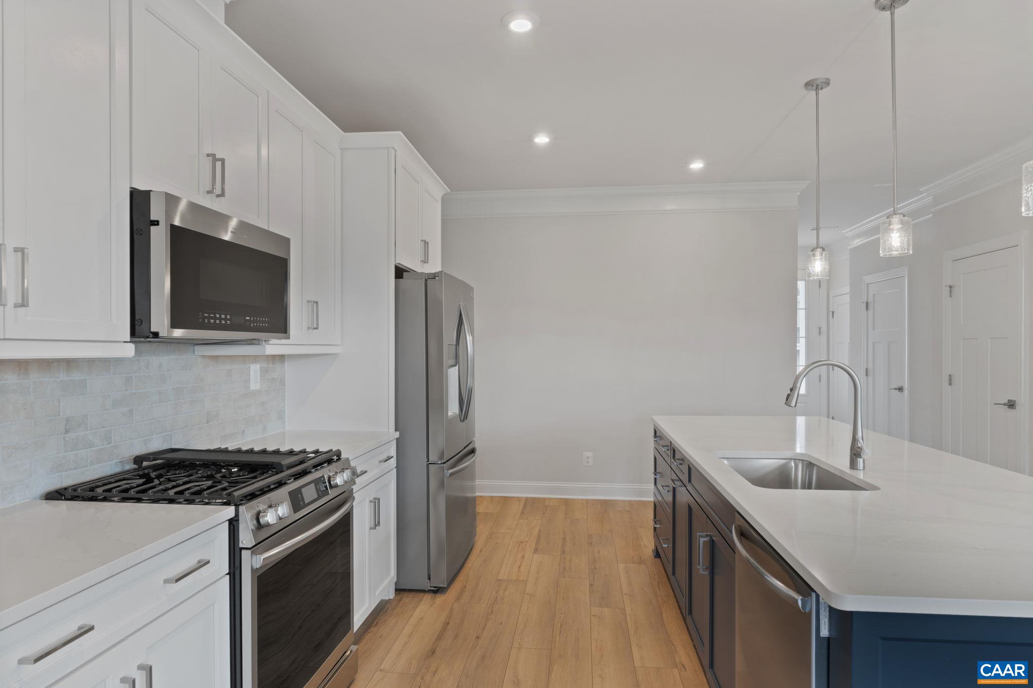 140 Springdale Road Waynesboro, VA 22980 - Photo 9 of 37 a kitchen with stainless steel appliances a sink a stove a microwave and wooden floor