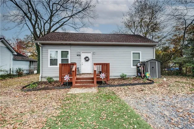a backyard of a house with barbeque oven table and chairs