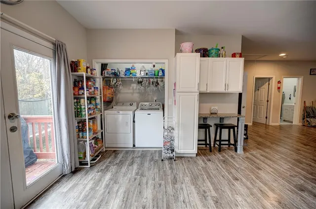 a view of kitchen with furniture and wooden floor
