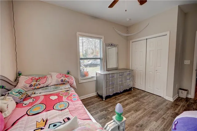 a bedroom with bed and a window