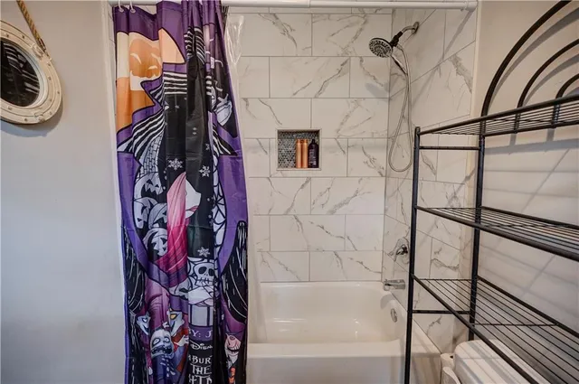 a bathroom with a bathtub and shower