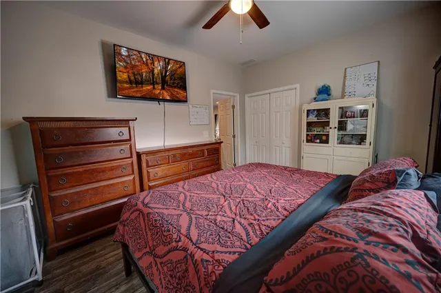 a bedroom with a bed and a flat screen tv