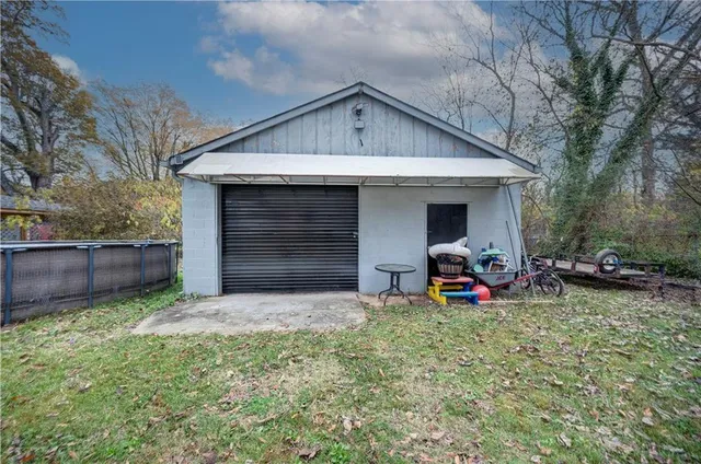 a view of a house with a yard and chairs