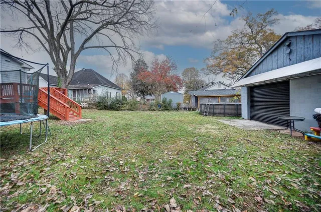 a backyard of a house with table and chairs