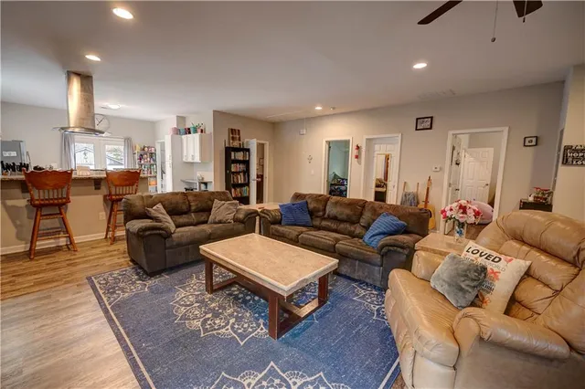 a living room with furniture a rug and a lamp