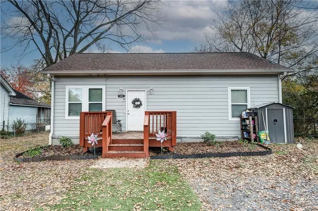 a backyard of a house with barbeque oven table and chairs