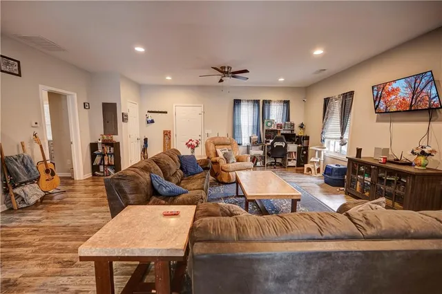 a living room with furniture and wooden floor