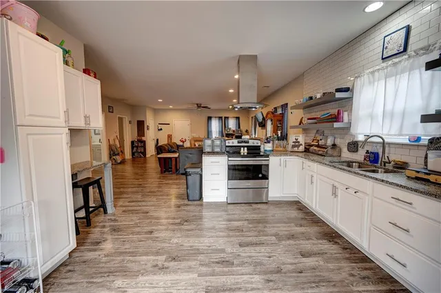 a large kitchen with stainless steel appliances and a refrigerator