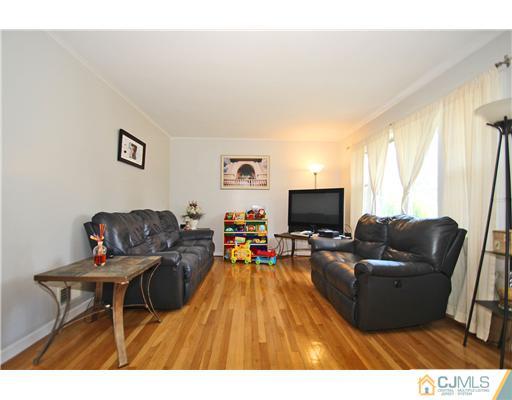 28 Sine Road Edison, NJ 08817 - Photo 3 of 23 a living room with furniture and a flat screen tv