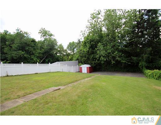 28 Sine Road Edison, NJ 08817 - Photo 22 of 23 a view of yard with swimming pool and trees