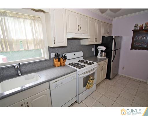 28 Sine Road Edison, NJ 08817 - Photo 8 of 23 a kitchen with stainless steel appliances granite countertop a sink stove and refrigerator