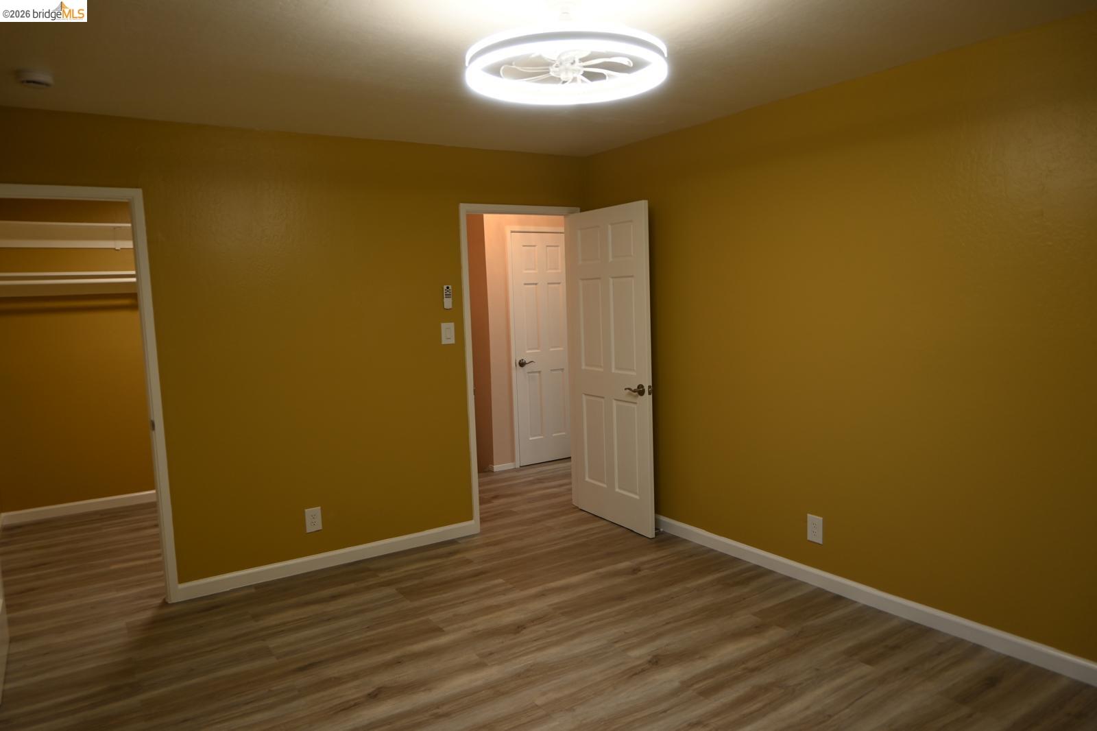 1316 Russell Street Berkeley, CA 94702 - Photo 16 of 23 an empty room with wooden floor and windows