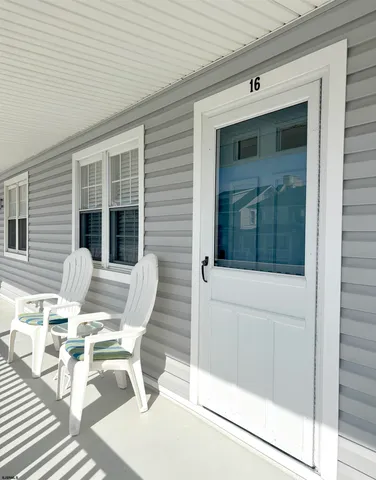 a view of a patio with table and chairs