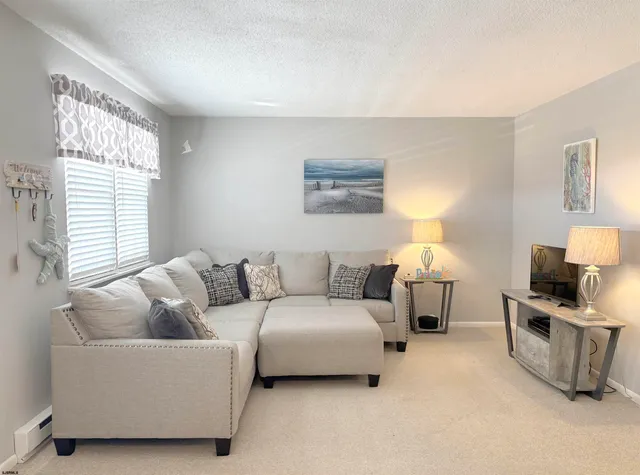 a living room with furniture and a lamp