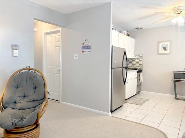a kitchen with stainless steel appliances granite countertop a refrigerator and a stove