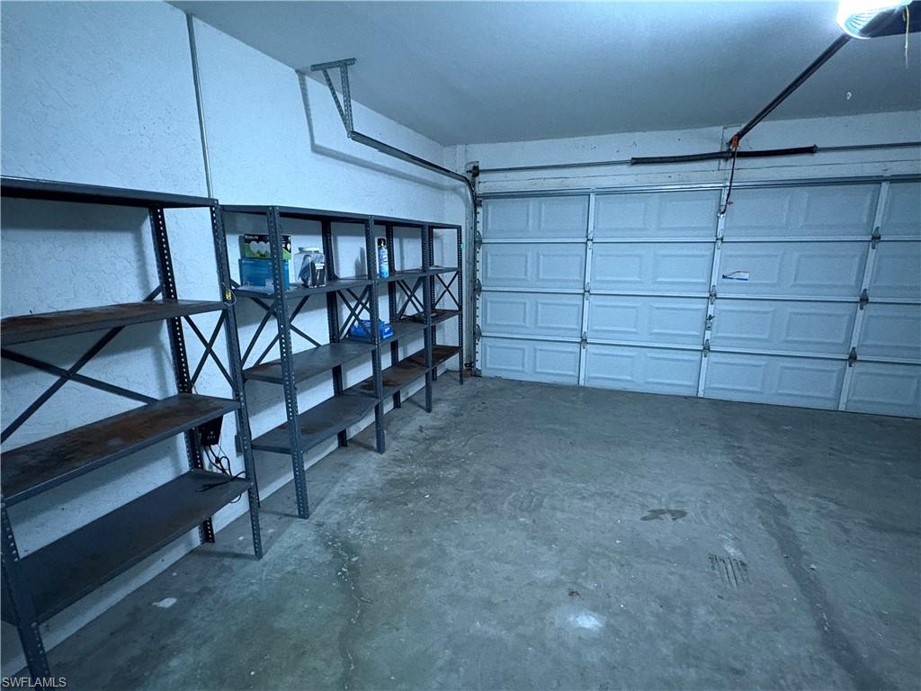 804 Bluebird Street Naples, FL 34104 - Photo 16 of 42 Garage with a garage door opener