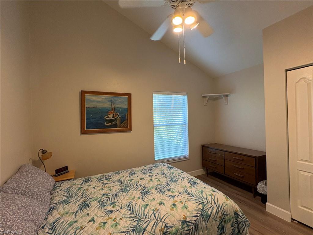 804 Bluebird Street Naples, FL 34104 - Photo 17 of 42 Bedroom with lofted ceiling, ceiling fan, and dark wood finished floors