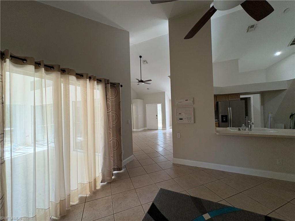804 Bluebird Street Naples, FL 34104 - Photo 20 of 42 Hall featuring light tile patterned floors and high vaulted ceiling