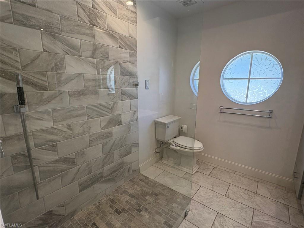 804 Bluebird Street Naples, FL 34104 - Photo 22 of 42 Full bathroom with baseboards and walk in shower