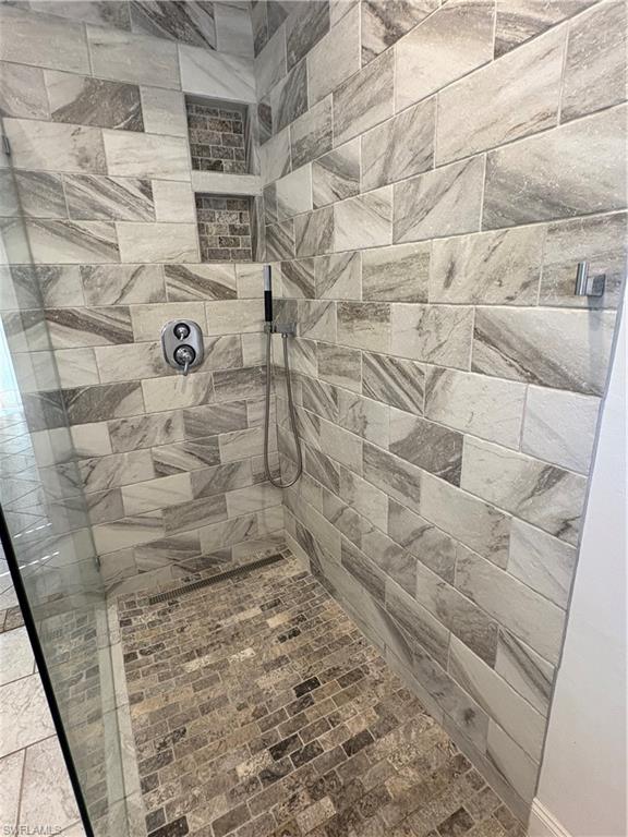 804 Bluebird Street Naples, FL 34104 - Photo 36 of 42 Full bathroom featuring tiled shower