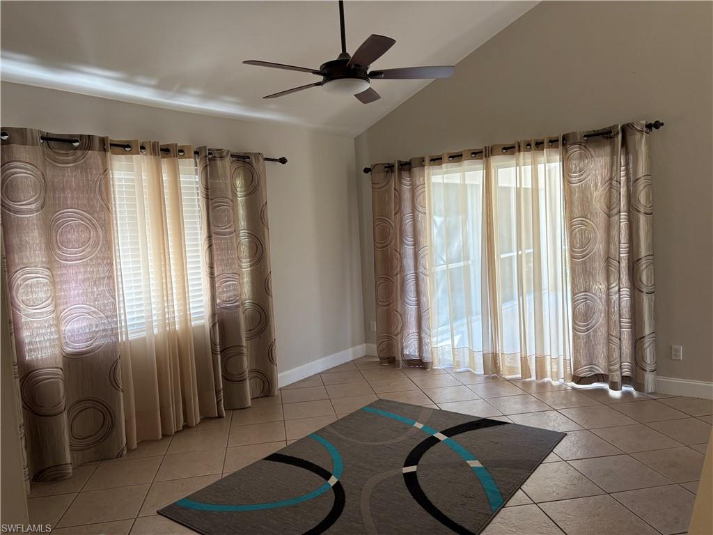804 Bluebird Street Naples, FL 34104 - Photo 38 of 42 Exercise room with light tile patterned floors, lofted ceiling, and ceiling fan
