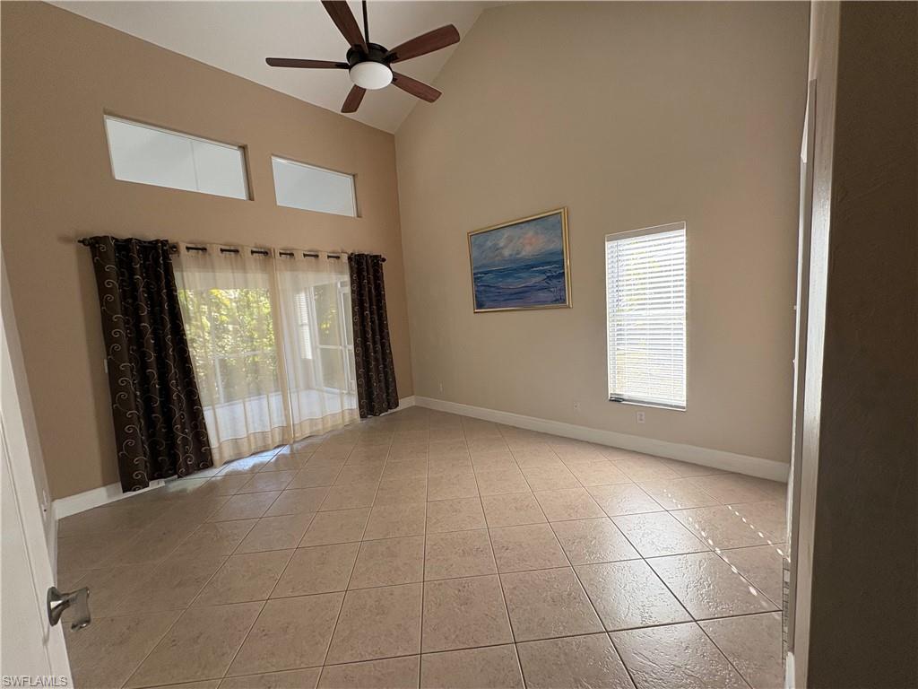 804 Bluebird Street Naples, FL 34104 - Photo 6 of 42 primary room with high vaulted ceiling, a ceiling fan, and light tile patterned flooring