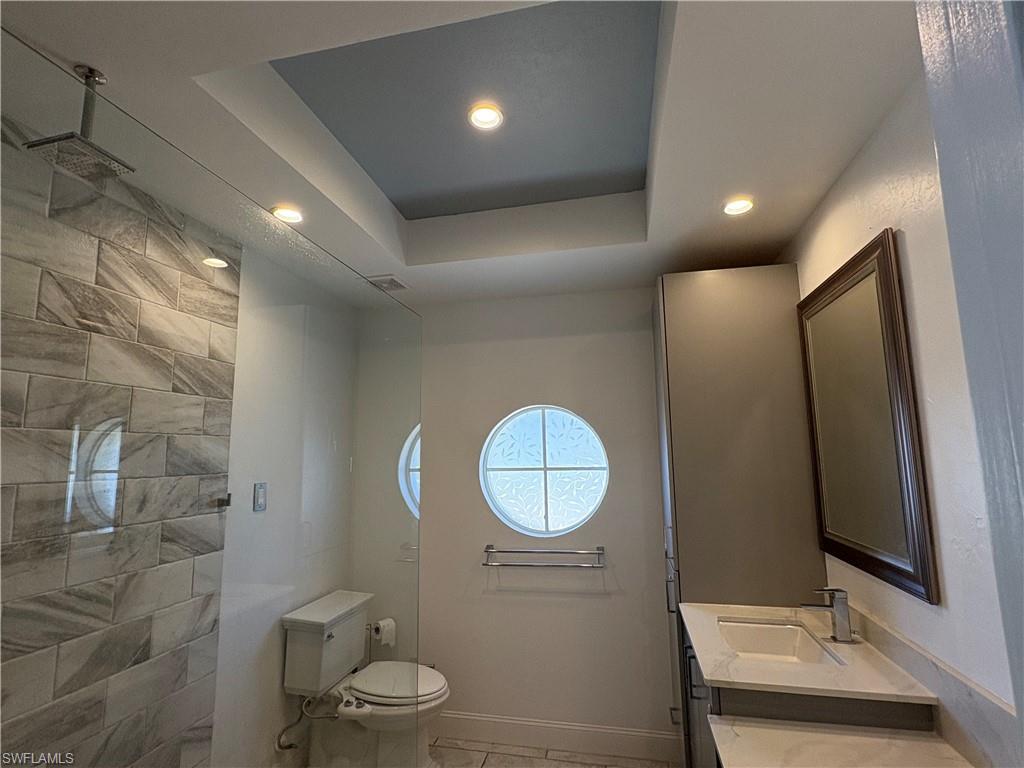 804 Bluebird Street Naples, FL 34104 - Photo 8 of 42 Full bath with a raised ceiling, vanity, recessed lighting, and walk in shower