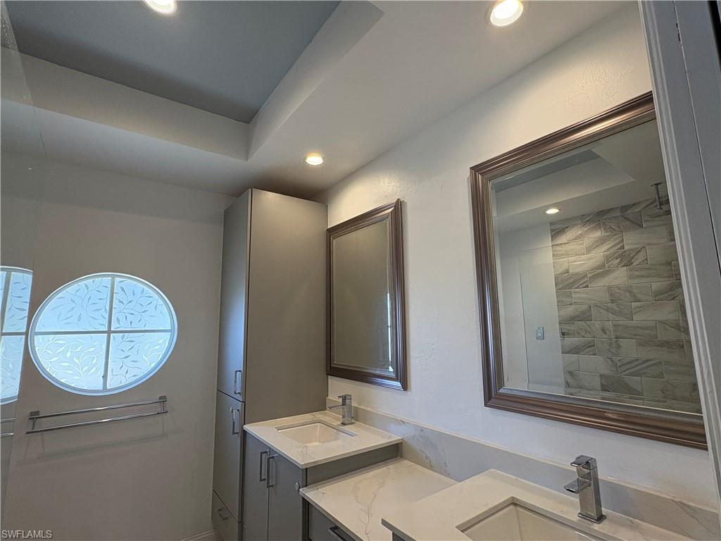 804 Bluebird Street Naples, FL 34104 - Photo 10 of 42 Full bathroom with double vanity and recessed lighting