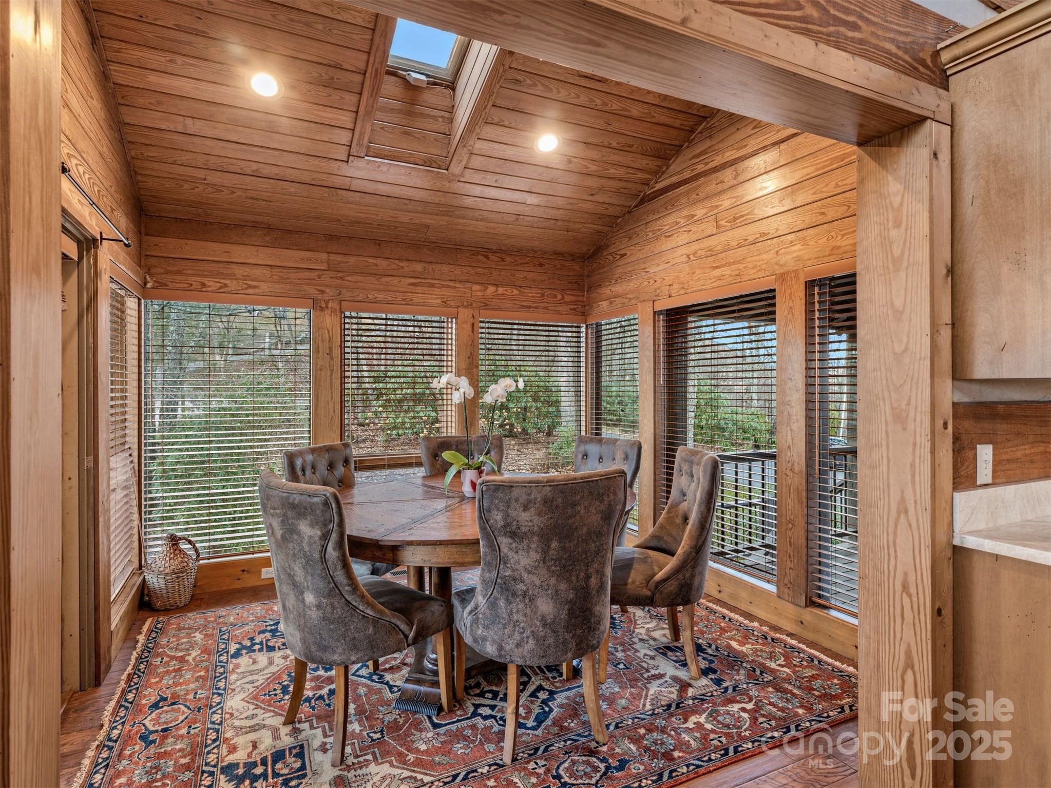 135 Grouse Point Road Maggie Valley, NC 28751 - Photo 12 of 48 a view of a dining room with furniture window and wooden floor