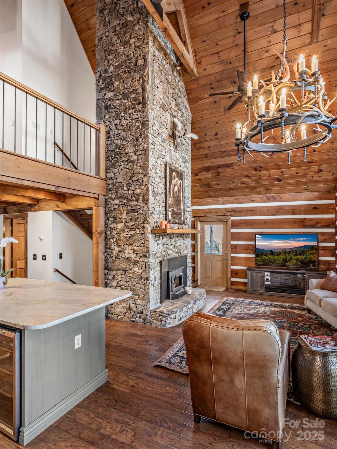 135 Grouse Point Road Maggie Valley, NC 28751 - Photo 18 of 48 a bedroom with a bed and a fireplace