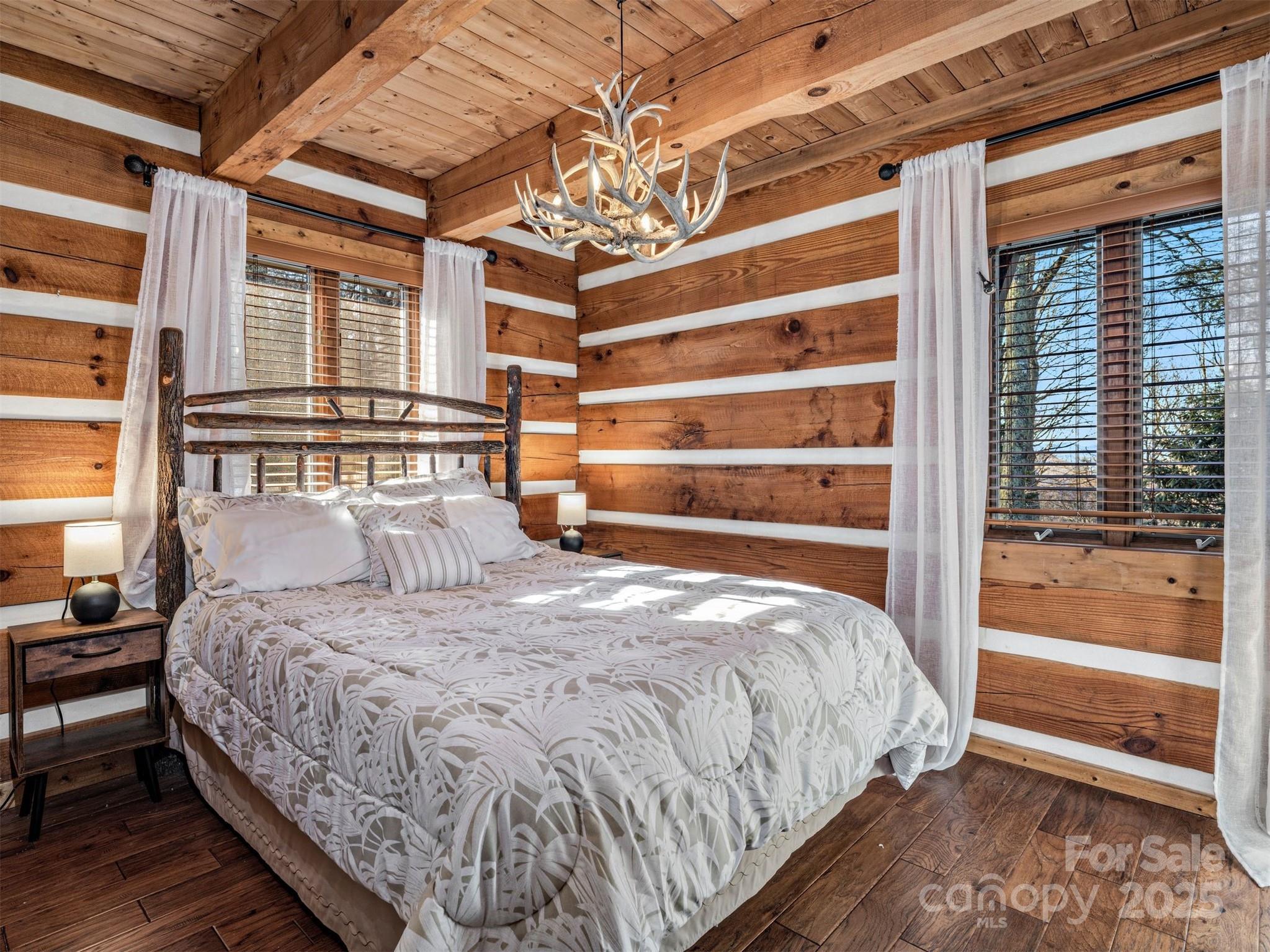135 Grouse Point Road Maggie Valley, NC 28751 - Photo 19 of 48 a bedroom with a bed and a window