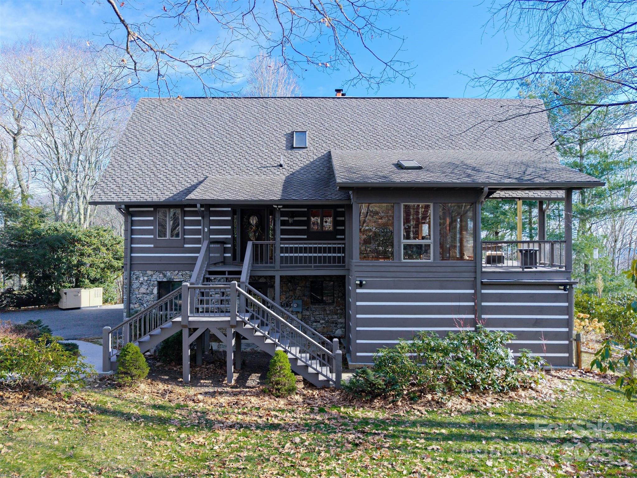 135 Grouse Point Road Maggie Valley, NC 28751 - Photo 2 of 48 a front view of a house with a yard