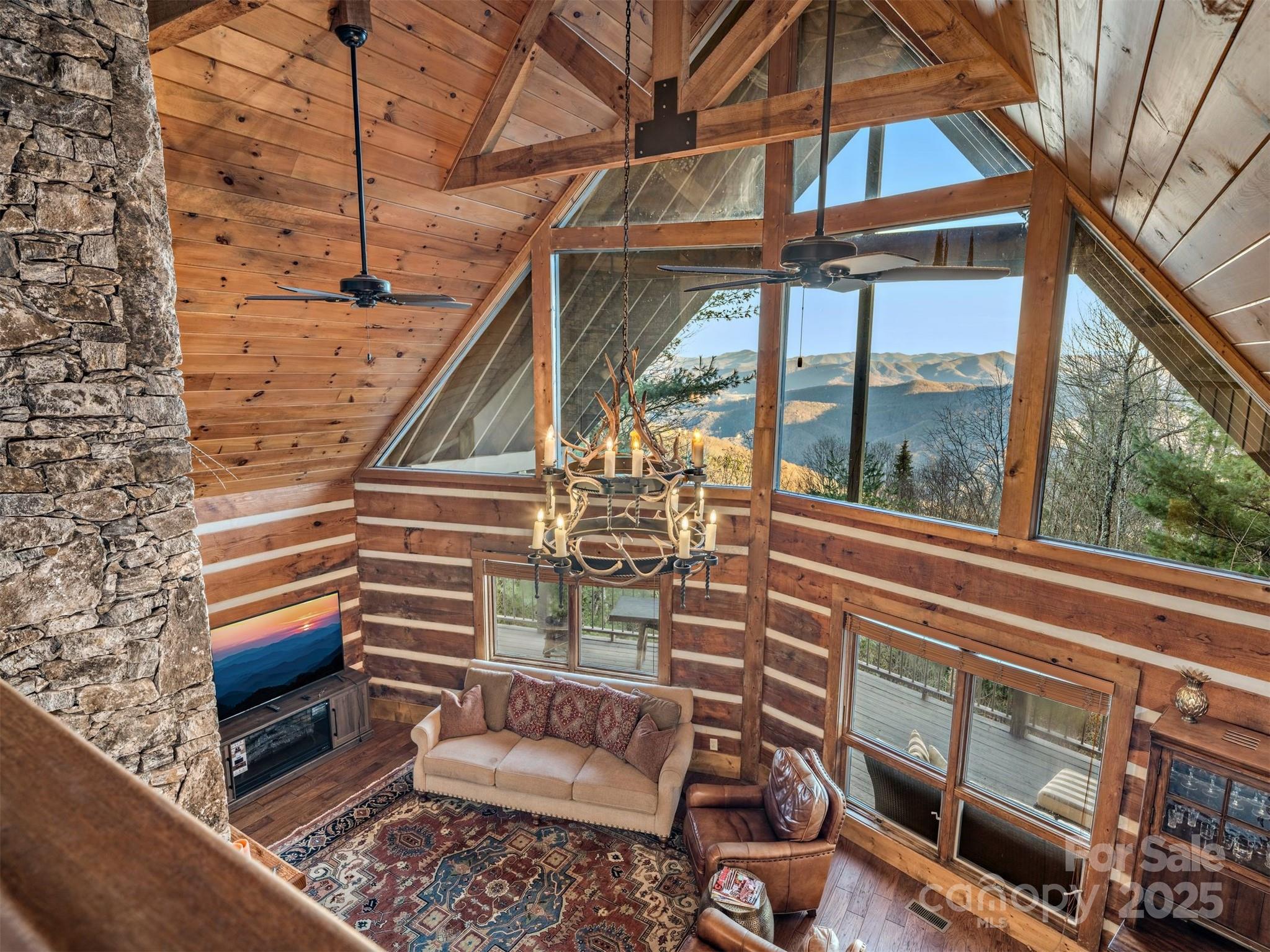 135 Grouse Point Road Maggie Valley, NC 28751 - Photo 23 of 48 a roof deck with table and chairs and potted plants