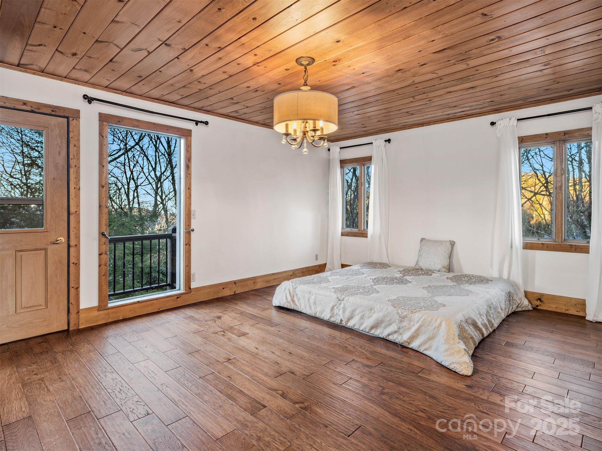 135 Grouse Point Road Maggie Valley, NC 28751 - Photo 24 of 48 a spacious bedroom with a bed and a window