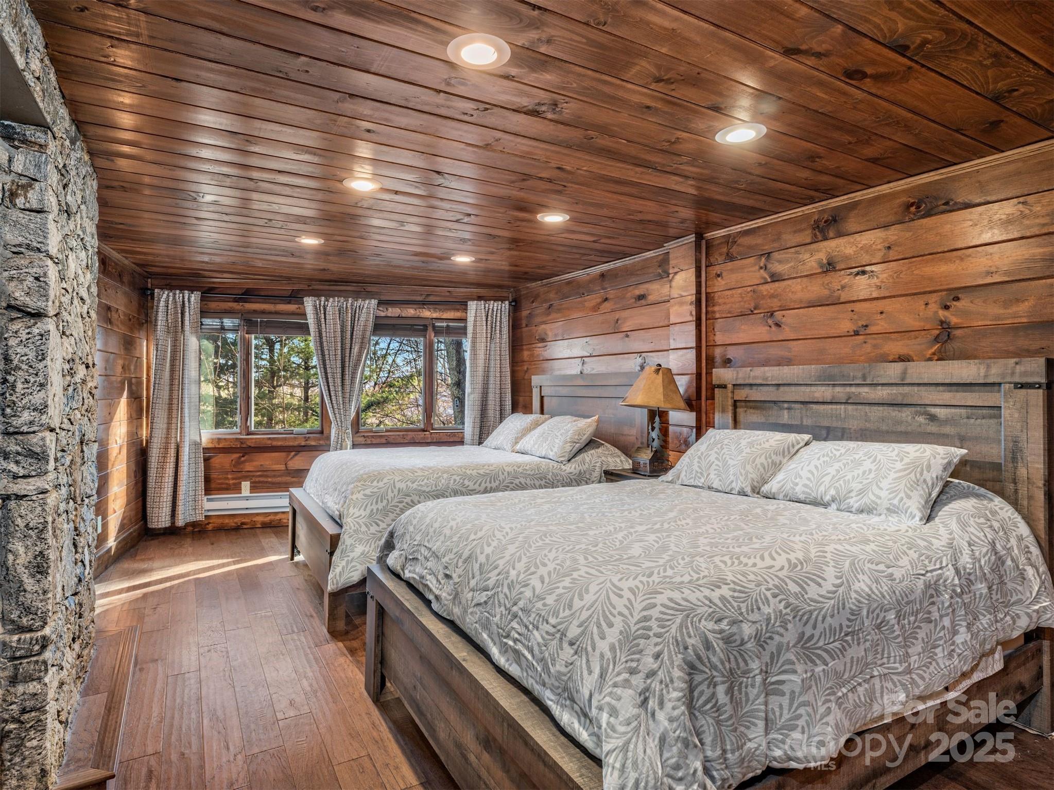 135 Grouse Point Road Maggie Valley, NC 28751 - Photo 30 of 48 a bed room with a bed and a large window