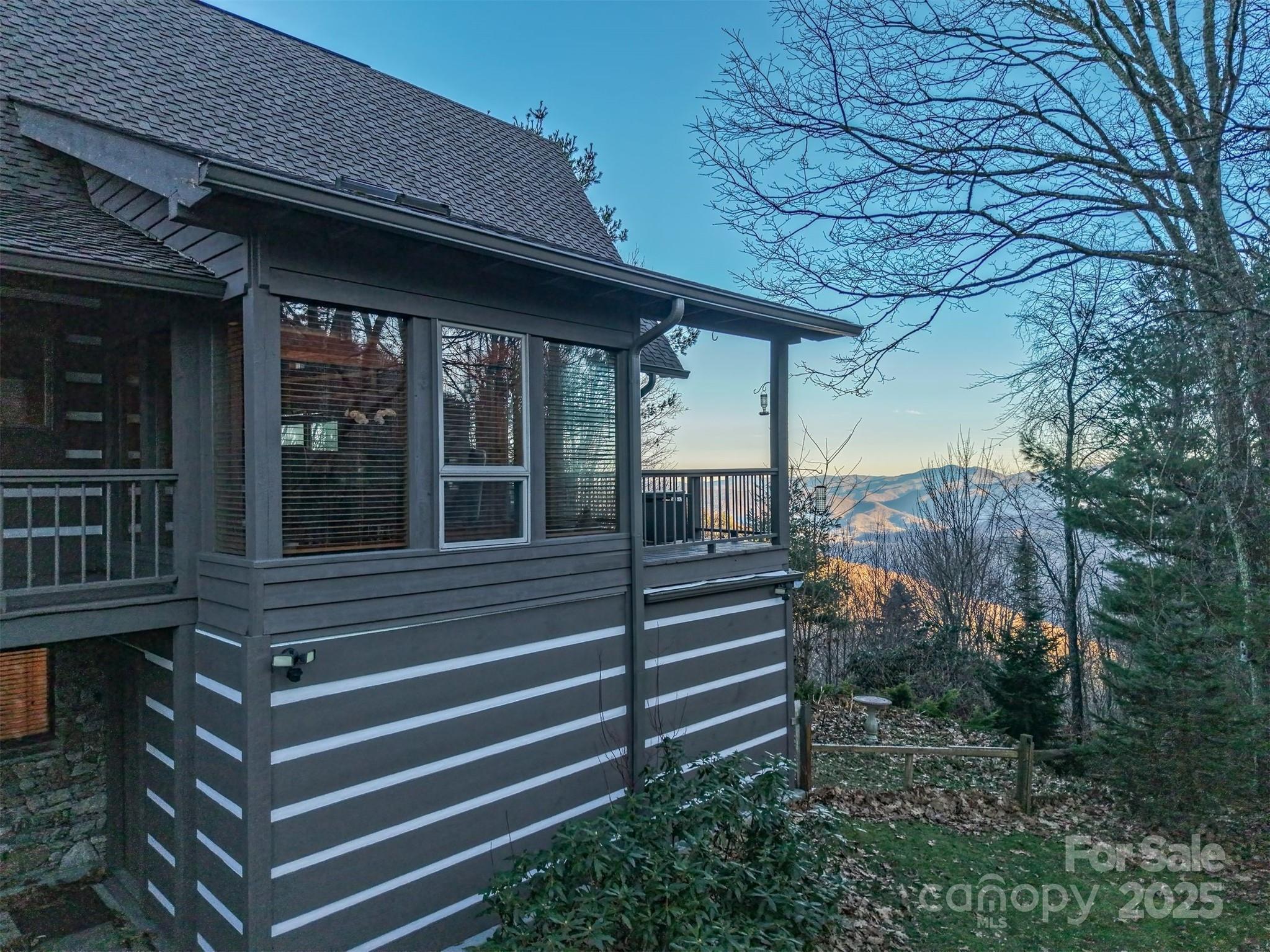 135 Grouse Point Road Maggie Valley, NC 28751 - Photo 3 of 48 a view of a house with a large window and wooden fence